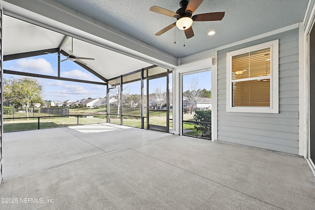 unfurnished sunroom with lofted ceiling and ceiling fan