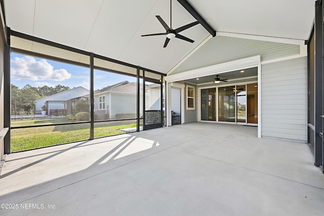 unfurnished sunroom with ceiling fan and lofted ceiling with beams