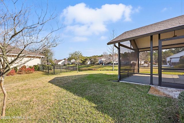 view of yard with a sunroom and fence