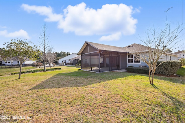 exterior space featuring a sunroom and a yard