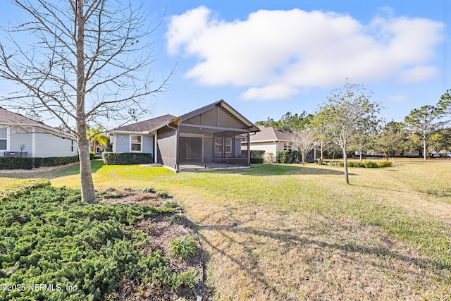 view of front of house featuring a front yard and a sunroom