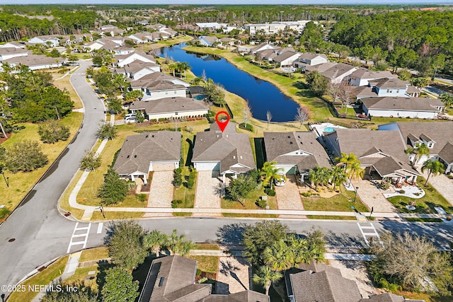 birds eye view of property with a residential view and a water view