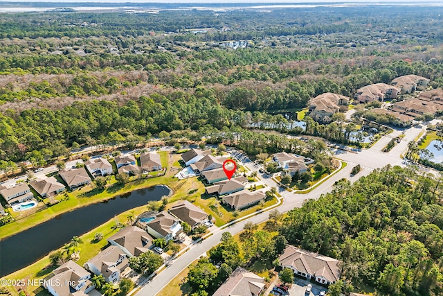 birds eye view of property with a water view and a residential view