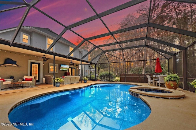 view of pool featuring an outdoor hangout area, a patio area, a lanai, and a ceiling fan