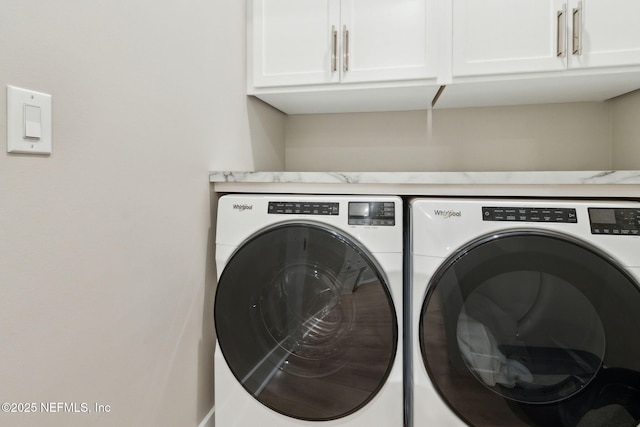 laundry area with cabinet space and independent washer and dryer