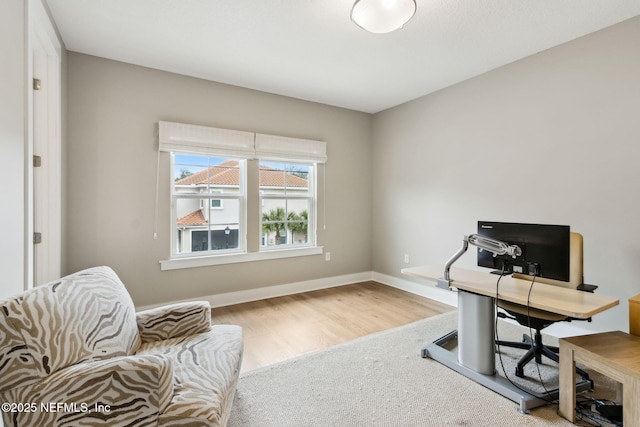 office space featuring baseboards and wood finished floors