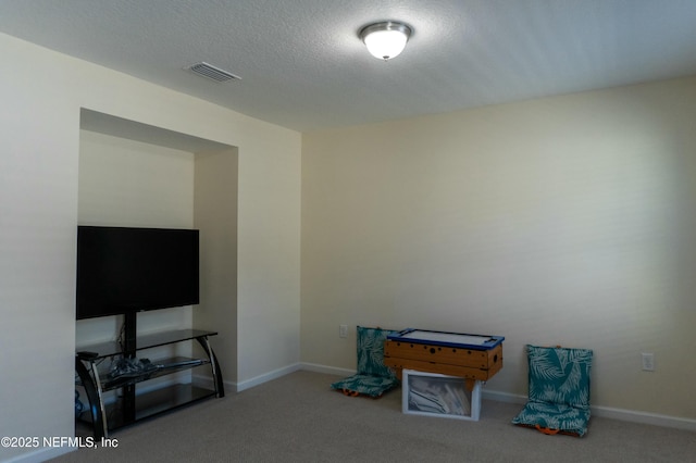 game room with baseboards, a textured ceiling, visible vents, and carpet flooring