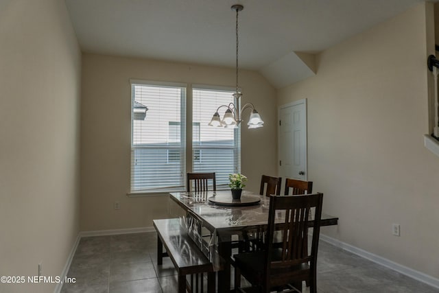 tiled dining room featuring vaulted ceiling, a notable chandelier, and baseboards