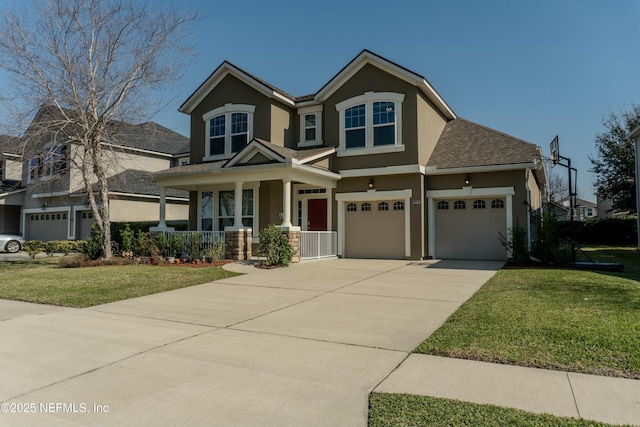 view of front facade featuring covered porch, a shingled roof, driveway, stucco siding, and a front lawn