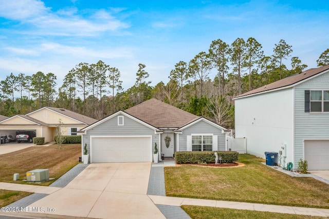 view of front of property featuring a garage, a front yard, concrete driveway, and roof with shingles