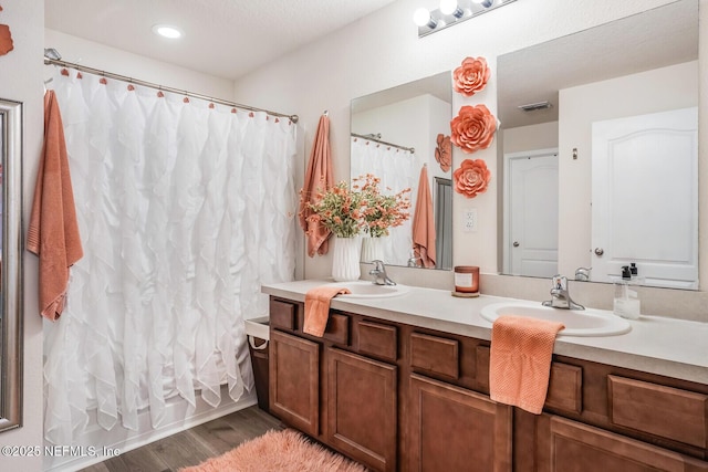 95170 Timberlake Dr, Fernandina Beach, FL 32034 - bathroom with double vanity, wood finished floors, a sink, and visible vents
