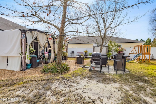 95170 Timberlake Dr, Fernandina Beach, FL 32034 - view of yard with a fenced backyard, a pergola, and a playground