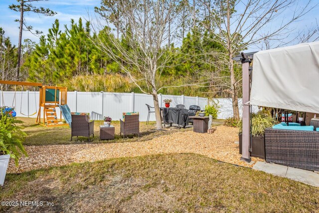 95170 Timberlake Dr, Fernandina Beach, FL 32034 - view of yard featuring a fenced backyard, outdoor lounge area, and a playground