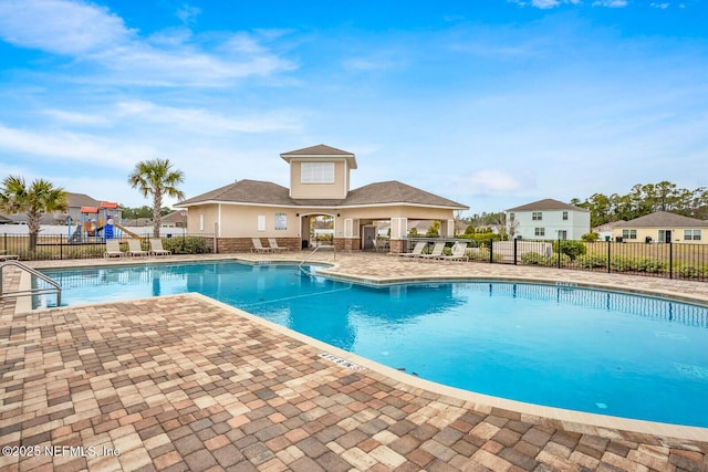 95170 Timberlake Dr, Fernandina Beach, FL 32034 - community pool featuring a residential view, a patio area, playground community, and fence