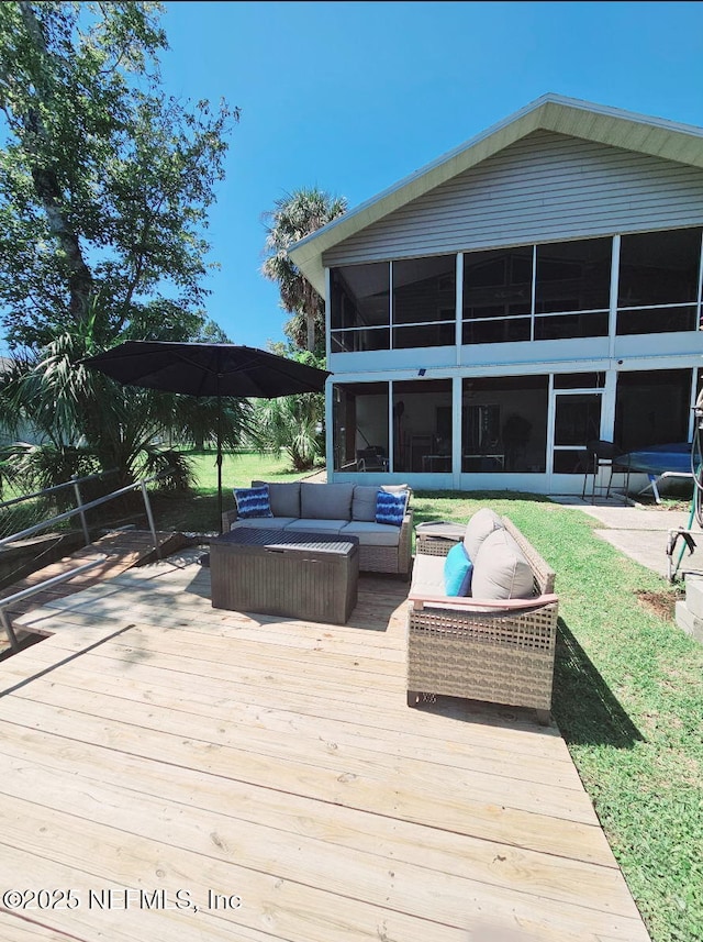 deck with a sunroom and an outdoor living space