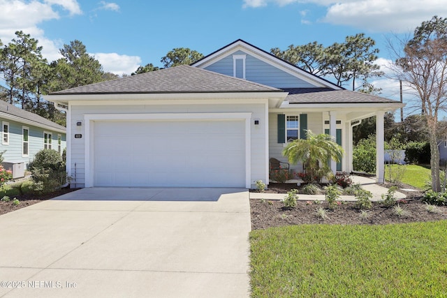 view of front facade with a garage, concrete driveway, and roof with shingles