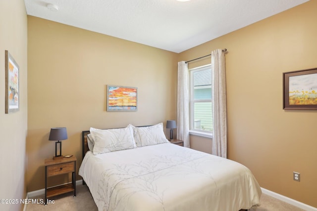 bedroom featuring carpet and baseboards