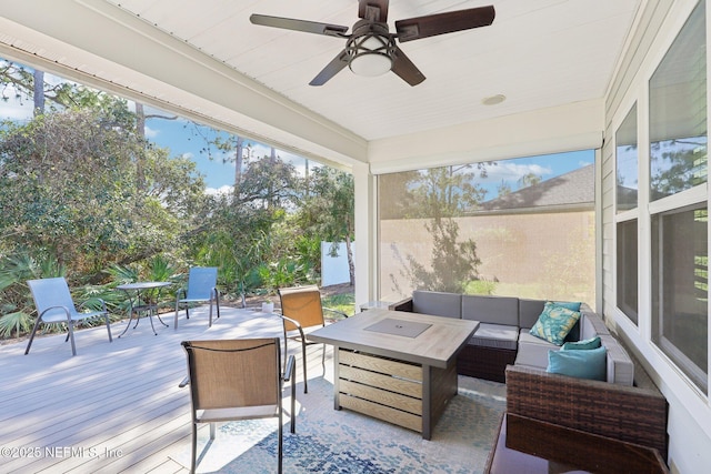 sunroom featuring a ceiling fan and a wealth of natural light