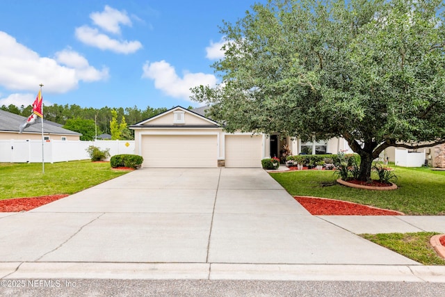 view of front of property featuring fence, an attached garage, concrete driveway, and a front lawn