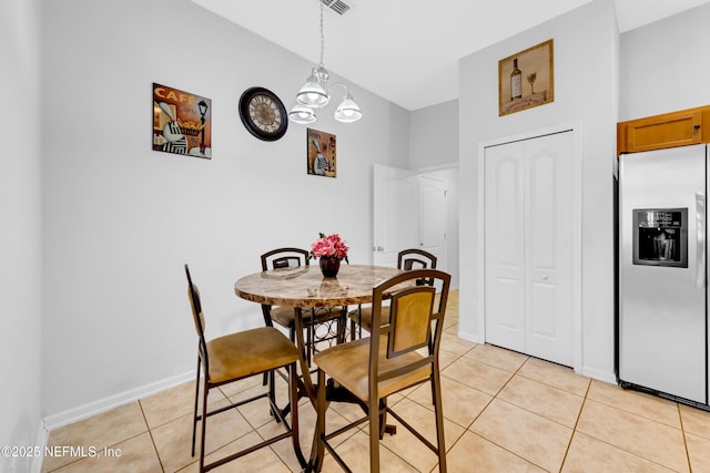 dining space with baseboards, an inviting chandelier, and light tile patterned floors