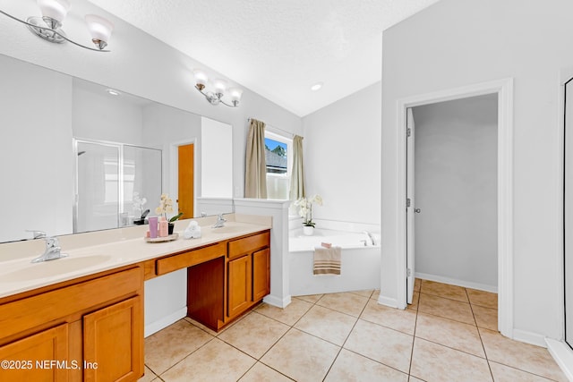 bathroom featuring double vanity, a stall shower, a sink, tile patterned floors, and lofted ceiling