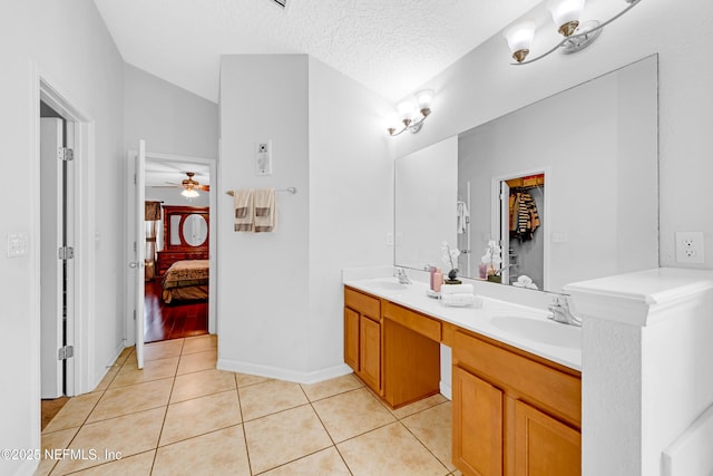 ensuite bathroom featuring ensuite bathroom, a sink, a ceiling fan, and tile patterned floors