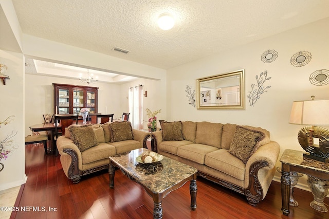 4023 Trail Ridge Rd, Middleburg, FL 32068 - living area featuring a textured ceiling, wood-type flooring, a chandelier, and baseboards