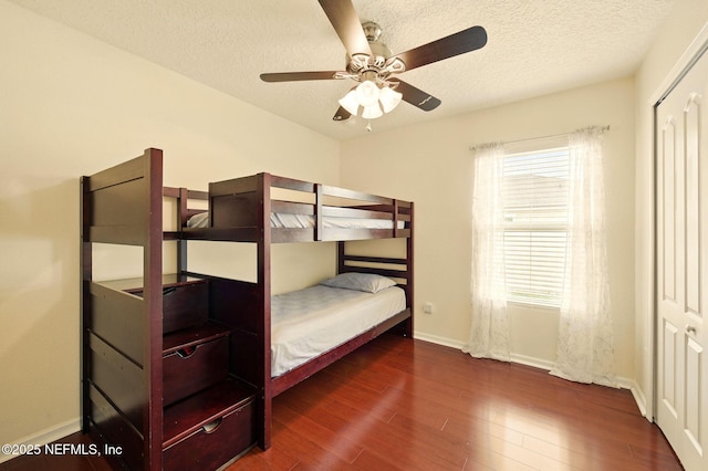 4023 Trail Ridge Rd, Middleburg, FL 32068 - bedroom featuring wood finished floors, baseboards, a textured ceiling, a closet, and ceiling fan