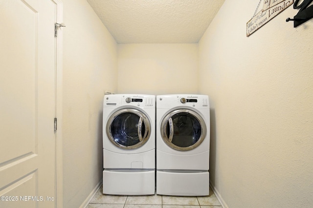 4023 Trail Ridge Rd, Middleburg, FL 32068 - laundry room with washing machine and clothes dryer, a textured ceiling, baseboards, and light tile patterned floors