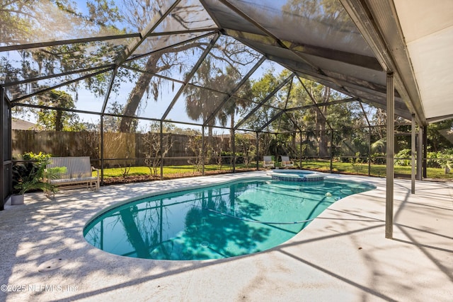 view of pool featuring a patio area, fence, a pool with connected hot tub, and a lanai