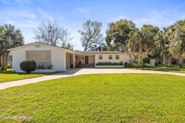 ranch-style home featuring driveway, a front yard, and brick siding