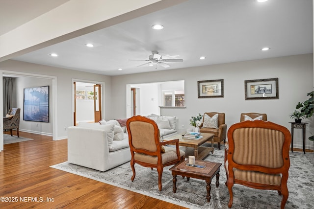 living area with baseboards, wood finished floors, a ceiling fan, and recessed lighting