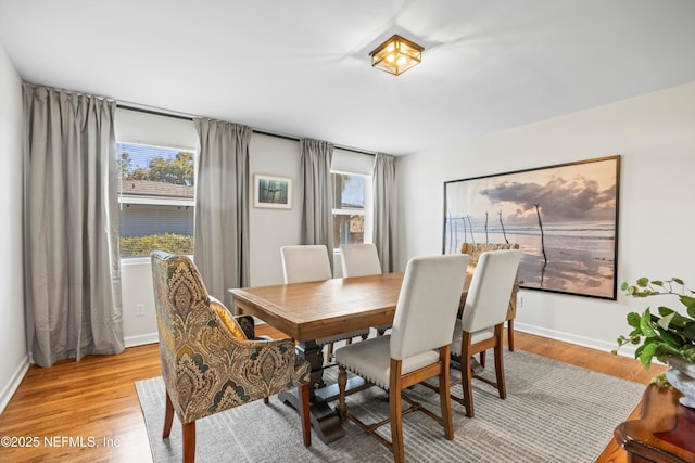 dining room with light wood-style floors and baseboards