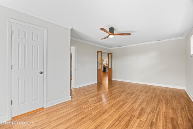 unfurnished room featuring ornamental molding, baseboards, light wood finished floors, and a ceiling fan