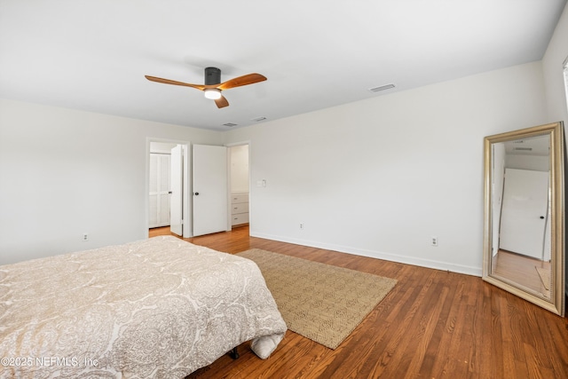 bedroom with visible vents, ceiling fan, baseboards, and wood finished floors