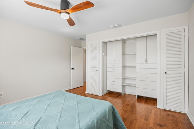 bedroom featuring a ceiling fan, a closet, visible vents, and wood finished floors