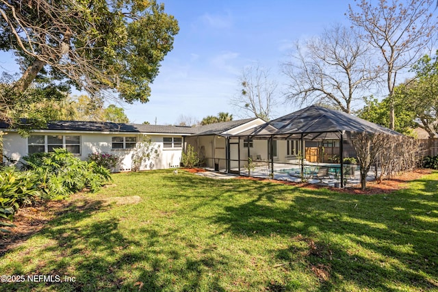 back of house featuring a yard, a lanai, an outdoor pool, and stucco siding