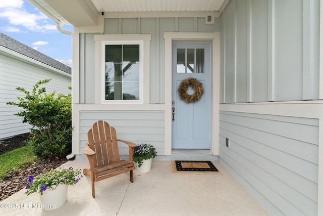 view of exterior entry with board and batten siding