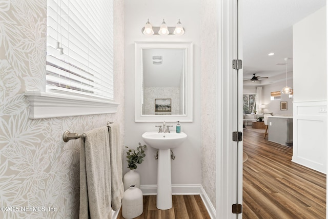 bathroom featuring a sink, wood finished floors, and baseboards