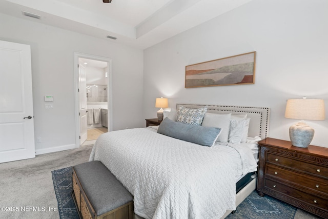 bedroom featuring baseboards, connected bathroom, visible vents, and carpet flooring