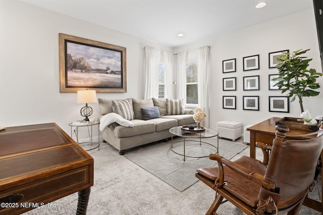 carpeted living room with recessed lighting and baseboards