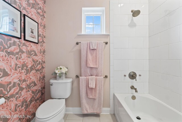 bathroom featuring toilet, shower / tub combination, baseboards, and tile patterned floors