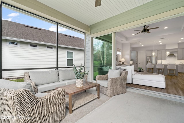 sunroom featuring plenty of natural light and ceiling fan