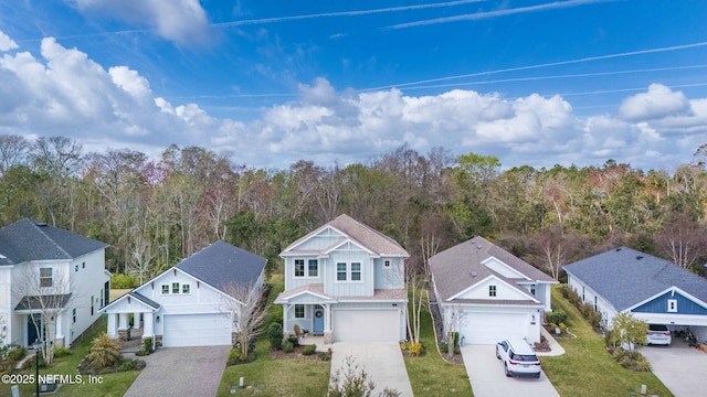 birds eye view of property with a wooded view