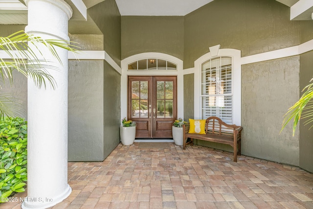 doorway to property featuring french doors and stucco siding