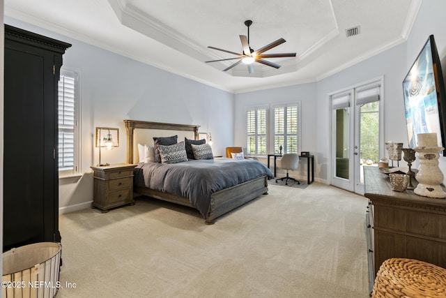 bedroom featuring access to exterior, a raised ceiling, light carpet, and ornamental molding