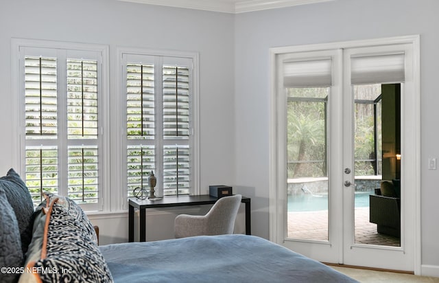 bedroom with access to outside and crown molding