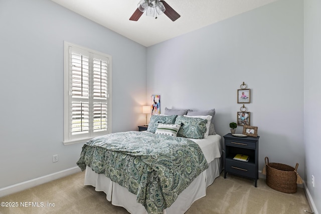 bedroom featuring light carpet, ceiling fan, and baseboards