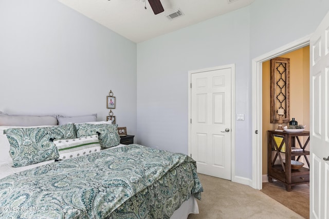 carpeted bedroom with baseboards, visible vents, and a ceiling fan