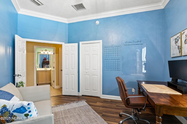 office with visible vents, crown molding, and wood finished floors